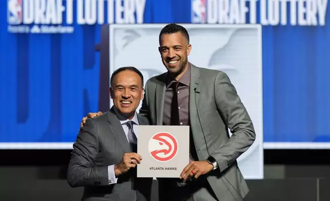 FILE - Atlanta Hawks general manager Landry Fields, right, and NBA Deputy Commissioner Mark Tatum pose for photos after Tatum announced that the Hawks had won the first pick in the NBA draft, during the draft lottery in Chicago, Sunday, May 12, 2024. (AP Photo/Nam Y. Huh, File