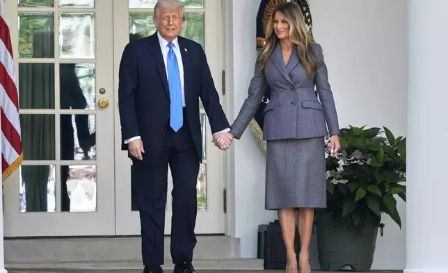 President Donald Trump and first lady Melania Trump arrive in the Rose Garden at the White House, Monday, May 19, 2025 in Washington, where President Trump will sign the "Take It Down Act". (AP Photo/Manuel Balce Ceneta)