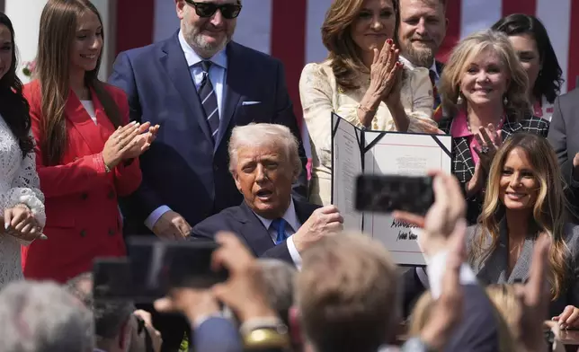 President Donald Trump, with first lady Melania Trump and others, after signing the "Take It Down Act" during a ceremony in the Rose Garden at the White House, Monday, May 19, 2025. (AP Photo/Manuel Balce Ceneta)