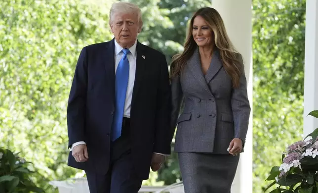 President Donald Trump, left, and first lady Melania Trump arrive to speak during a bill signing event for the "Take it Down Act" in the Rose Garden of the White House, Monday, May 19, 2025, in Washington. (AP Photo/Evan Vucci)