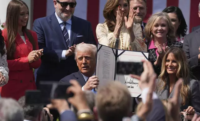 President Donald Trump, with first lady Melania Trump and others, after signing the "Take It Down Act" during a ceremony in the Rose Garden at the White House, Monday, May 19, 2025. (AP Photo/Manuel Balce Ceneta)