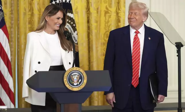 President Donald Trump, right, watches as first lady Melania Trump speaks at an event for Military Mothers, Thursday, May 8, 2025, in the East Room of the White House in Washington. (AP Photo/Jacquelyn Martin)