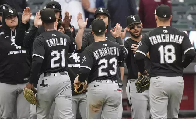 Chicago White Sox's Mike Tauchman (18), Andrew Benintendi (23) and Michael A. Taylor (21) celebrate with teammates after a baseball game against the New York Mets Wednesday, May 28, 2025, in New York. (AP Photo/Frank Franklin II)