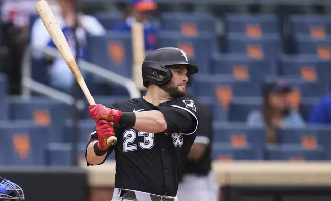 Chicago White Sox's Andrew Benintendi (23) follows through on a two-run single during the first inning of a baseball game against the New York Mets Wednesday, May 28, 2025, in New York. (AP Photo/Frank Franklin II)