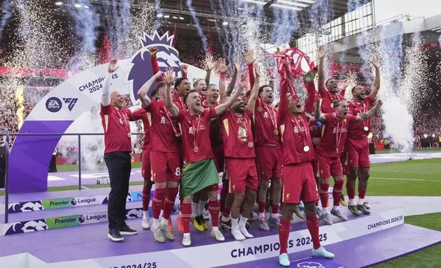 Liverpool players celebrate with the winner's trophy after the English Premier League soccer match between Liverpool and Crystal Palace at the Anfield stadium in Liverpool, England, Sunday, May 25, 2025. (AP Photo/Jon Super)