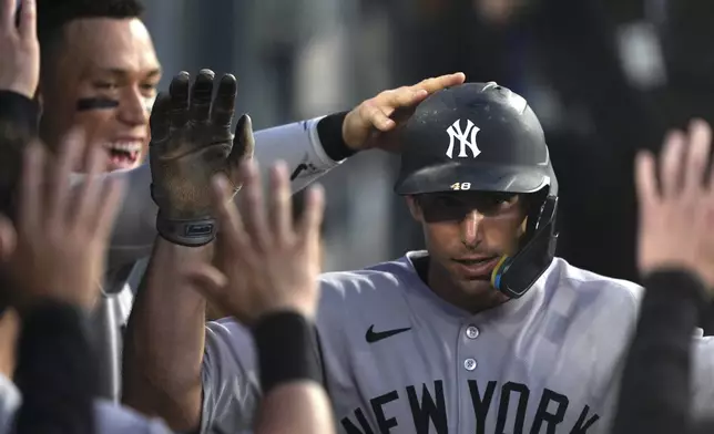 New York Yankees' Paul Goldschmidt is congratulated by teammates in the dugout after hitting a solo home run during the third inning of a baseball game against the Los Angeles Dodgers Friday, May 30, 2025, in Los Angeles. (AP Photo/Mark J. Terrill)