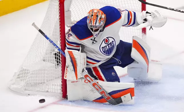 Edmonton Oilers goaltender Stuart Skinner eyes the puck during an attack by Dallas Stars in the third period of Game 2 of the Western Conference finals in the NHL hockey Stanley Cup playoffs, Friday, May 23, 2025, in Dallas. (AP Photo/LM Otero)