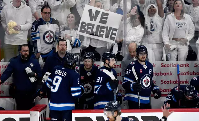 Winnipeg Jets' Vladislav Namestnikov (7) returns to the bench with teammates after scoring on the Dallas Stars during the third period of an NHL playoff hockey game in Winnipeg, Thursday, May 15, 2025. (Fred Greenslade/The Canadian Press via AP)