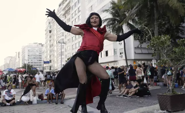 A fan strikes a pose as she waits for the start of Lady Gaga's free concert on Copacabana beach in Rio de Janeiro, Saturday, May 3, 2025. (AP Photo/Bruna Prado)