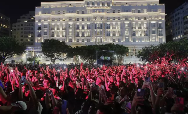 Fans watch Lady Gaga rehearse a day ahead of her free concert, on Copacabana beach, in Rio de Janeiro, Friday, May 2, 2025. (AP Photo/Bruna Prado)
