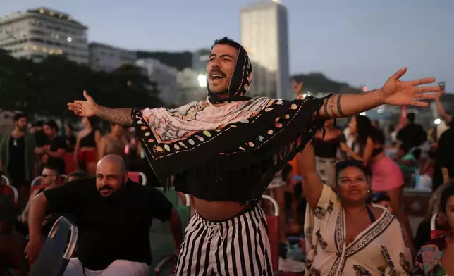 A fan cheers while waiting for the start of Lady Gaga's free concert on Copacabana beach in Rio de Janeiro, Saturday, May 3, 2025. (AP Photo/Bruna Prado)