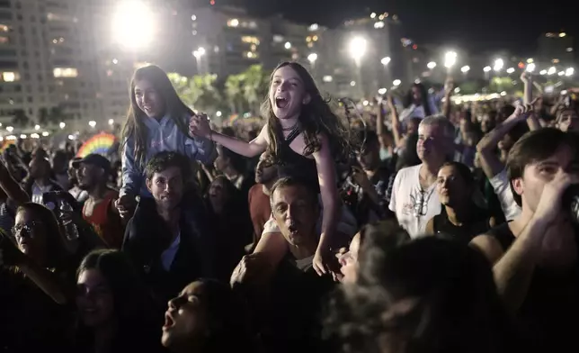 Fans cheer as they watch Lady Gaga free concert on Copacabana beach, in Rio de Janeiro, Sunday, May 4, 2025. (AP Photo/Bruna Prado)