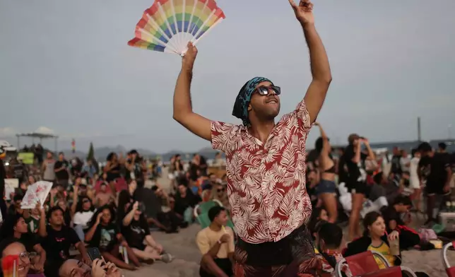 A fan cheers while waiting for the start of Lady Gaga's free concert on Copacabana beach in Rio de Janeiro, Saturday, May 3, 2025. (AP Photo/Bruna Prado)