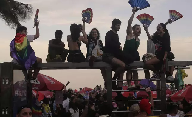 Fans cheer as they wait for the start of Lady Gaga's free concert on Copacabana beach in Rio de Janeiro, Saturday, May 3, 2025. (AP Photo/Bruna Prado)