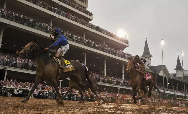 Sovereignty, ridden by Junior Alvarado, left, crosses the finish line to win the 151st running of the Kentucky Derby horse race followed by Journalism, ridden by Umberto Rispoli, at Churchill Downs Saturday, May 3, 2025, in Louisville, Ky. (AP Photo/Abbie Parr)