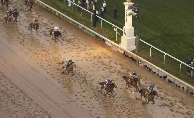 Sovereignty, ridden by Junior Alvarado, right, crosses the finish line to win the 151st running of the Kentucky Derby horse race at Churchill Downs Saturday, May 3, 2025, in Louisville, Ky. (AP Photo/Charlie Riedel)