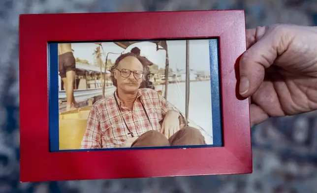 Cathy Votaw, 69, holds a photograph of her father, Albert Votaw, seen in Bangkok circa 1983 shortly before his death in a terror attack, Thursday, Feb. 27, 2025, in Washington. (AP Photo/Jacquelyn Martin)