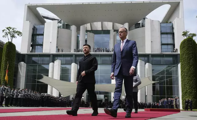 Germany's Chancellor Friedrich Merz, right, welcomes Ukraine's President Volodymyr Zelenskyy during an official military reception at the chancellery in Berlin, Germany, Wednesday, May 28, 2025.(AP Photo/Markus Schreiber)