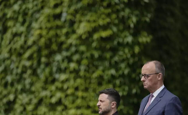 Germany's Chancellor Friedrich Merz, right, welcomes Ukraine's President Volodymyr Zelenskyy during an official military reception at the chancellery in Berlin, Germany, Wednesday, May 28, 2025.(AP Photo/Markus Schreiber)