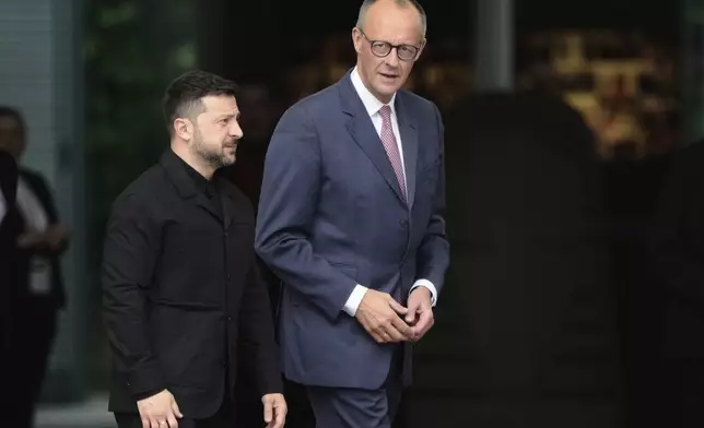 Germany's Chancellor Friedrich Merz, right, welcomes Ukraine's President Volodymyr Zelenskyy during an official military reception at the chancellery in Berlin, Germany, Wednesday, May 28, 2025.(AP Photo/Markus Schreiber)