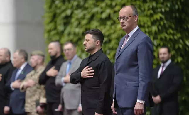 Germany's Chancellor Friedrich Merz, right, welcomes Ukraine's President Volodymyr Zelenskyy during an official military reception at the chancellery in Berlin, Germany, Wednesday, May 28, 2025.(AP Photo/Markus Schreiber)