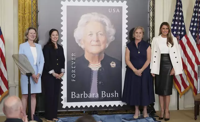First lady Melania Trump, from right, Dorothy Bush Koch, Alice Gonzalez Yates, CEO of the George and Barbara Bush Foundation, and Judy de Torok, vice president of corporate affairs at the U.S. Postal Service, unveil a U.S. Postal Service Stamp honoring former first lady Barbara Bush, Thursday, May 8, 2025, in the East Room of the White House in Washington. (AP Photo/Jacquelyn Martin)