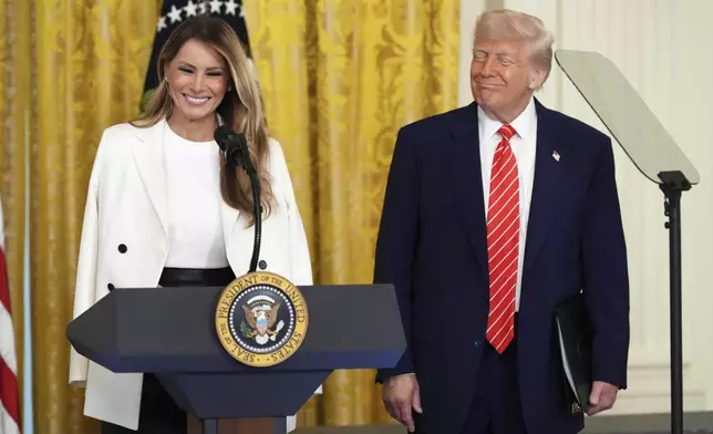 President Donald Trump, right, watches as first lady Melania Trump speaks at an event for Military Mothers, Thursday, May 8, 2025, in the East Room of the White House in Washington. (AP Photo/Jacquelyn Martin)