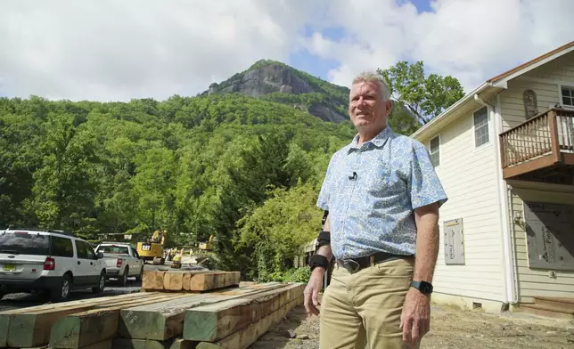 Mayor Peter O'Leary surveys work along Main Street in Chimney Rock Village, N.C., on Wednesday, May 14, 2025. (AP Photo/Allen G. Breed)