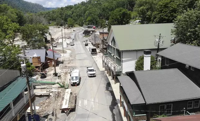 A truck drives down a nearly deserted Main Street in Chimney Rock Village, N.C., on Wednesday, May 14, 2025. (AP Photo/Allen G. Breed)
