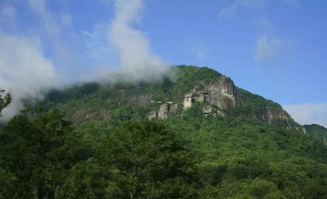 Morning mist burns off the geological formations in Chimney Rock Sate Park in Chimney Rock Village, N.C., on Wednesday, May 14, 2025. (AP Photo/Allen G. Breed)