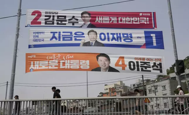 Banners featuring South Korea's People Power Party's presidential election candidate Kim Moon Soo, top, Democratic Party's presidential election candidate Lee Jae-myung and the New Reform Party's presidential election candidate Lee Jun-seok, bottom, hang for the June 3 presidential election at a street in Seoul, South Korea, Tuesday, May 13, 2025. (AP Photo/Ahn Young-joon)