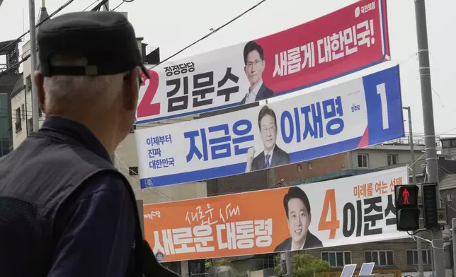 Banners featuring South Korea's People Power Party's presidential election candidate Kim Moon Soo, top, Democratic Party's presidential election candidate Lee Jae-myung and the New Reform Party's presidential election candidate Lee Jun-seok, bottom, hang for the June 3 presidential election at a street in Seoul, South Korea, Tuesday, May 13, 2025. (AP Photo/Ahn Young-joon)