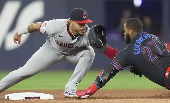 Toronto Blue Jays' Vladimir Guerrero Jr. is tagged out at second base by Cleveland Guardians second baseman Gabriel Arias during the first inning of a baseball game in Toronto on Friday, May 2, 2025. (Chris Young/The Canadian Press via AP)