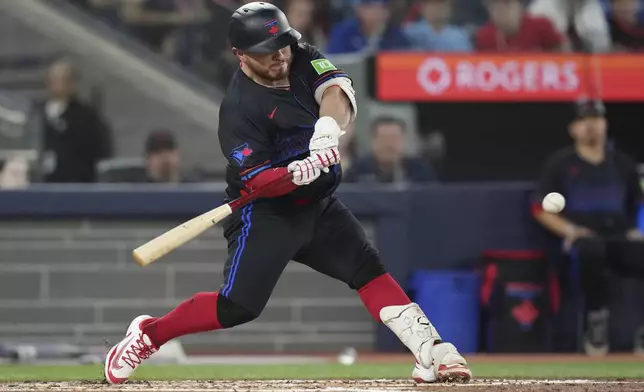 Toronto Blue Jays' Alejandro Kirk hits a two-run single off Cleveland Guardians pitcher Logan Allen during the third inning of a baseball game in Toronto on Friday, May 2, 2025. (Chris Young/The Canadian Press via AP)