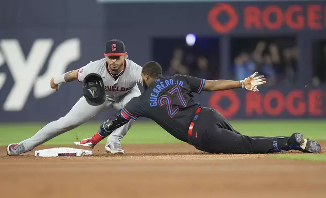 Toronto Blue Jays' Vladimir Guerrero Jr. is tagged out at second base by Cleveland Guardians second baseman Gabriel Arias during the first inning of a baseball game in Toronto on Friday, May 2, 2025. (Chris Young/The Canadian Press via AP)