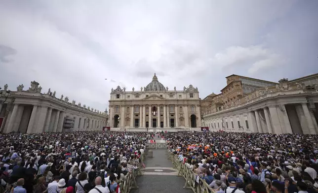 Faithful and well-wishers crowd St. Peter's Square as Pope Leo XIV appears at the central balcony of St. Peter's Basilica for his first Sunday blessing after his election, at the Vatican, Sunday, May 11, 2025.(AP Photo/Andrew Medichini)