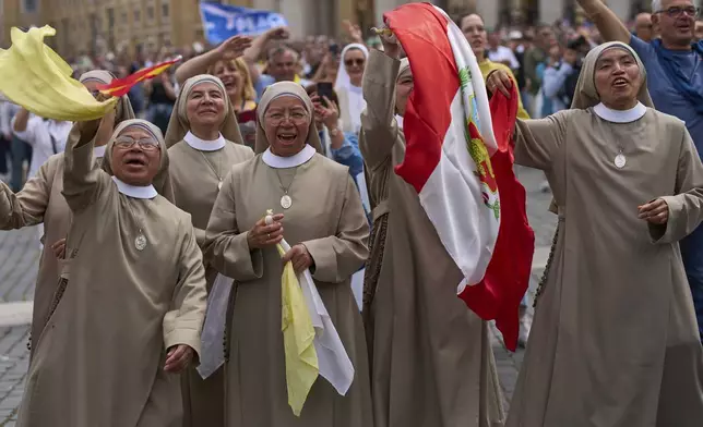 Nuns cheer during Pope Leo XIV's appearance from the central balcony of St. Peter's Basilica for his first Sunday blessing after his election, in St. Peter's Square at the Vatican, Sunday, May 11, 2025.(AP Photo/Bernat Armangue)