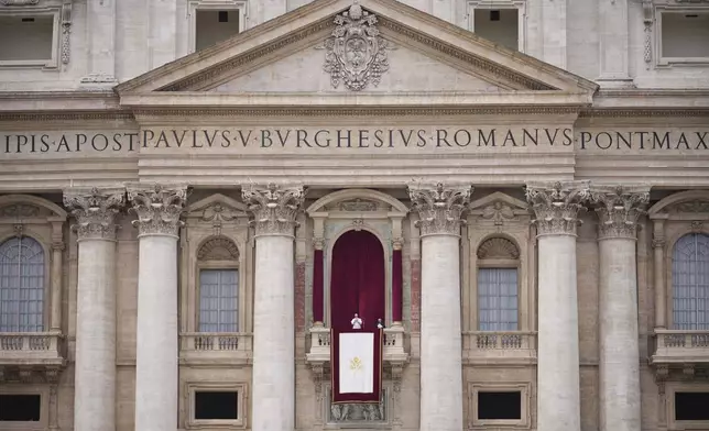 Pope Leo XIV appears at the central balcony of St. Peter's Basilica for his first Sunday blessing after his election, in St. Peter's Square at the Vatican, Sunday, May 11, 2025.(AP Photo/Andrew Medichini)