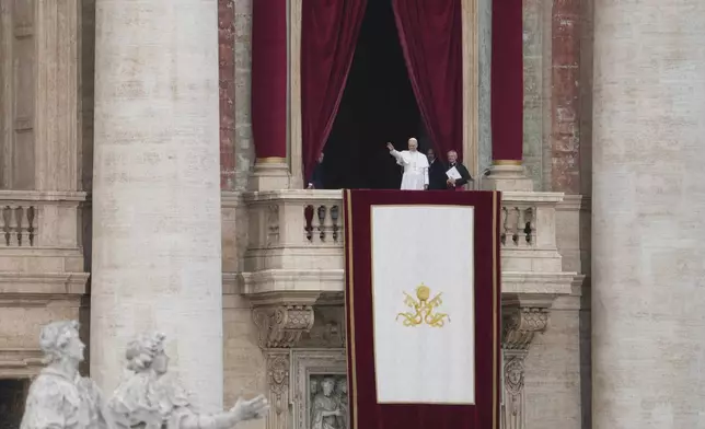 Pope Leo XIV appears at the central balcony of St. Peter's Basilica for his first Sunday blessing after his election, in St. Peter¥s Square at the Vatican, Sunday May 11, 2025. (AP Photo/Alessandra Tarantino)