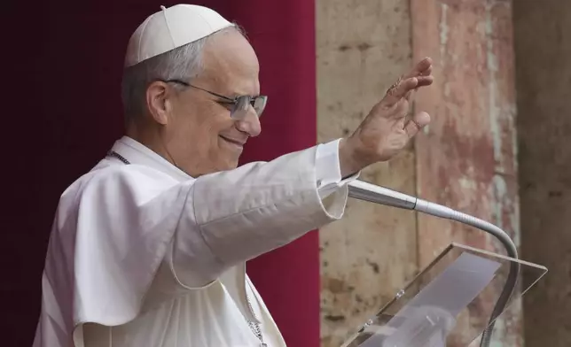 Pope Leo XIV appears at the central balcony of St. Peter's Basilica for his first Sunday blessing after his election, in St. Peter's Square at the Vatican, Sunday May 11, 2025. (AP Photo/Domenico Stinellis)