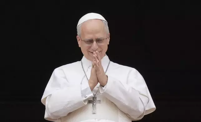 Pope Leo XIV appears at the central balcony of St. Peter's Basilica for his first Sunday blessing after his election, in St. Peter's Square at the Vatican, Sunday, May 11, 2025.(AP Photo/Gregorio Borgia)