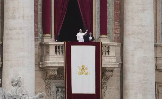 Pope Leo XIV appears at the central balcony of St. Peter's Basilica for his first Sunday blessing after his election, in St. Peter¥s Square at the Vatican, Sunday May 11, 2025. (AP Photo/Alessandra Tarantino)