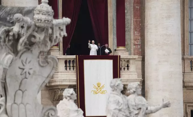 Pope Leo XIV appears at the central balcony of St. Peter's Basilica for his first Sunday blessing after his election, in St. Peter's Square at the Vatican, Sunday May 11, 2025. (AP Photo/Alessandra Tarantino)
