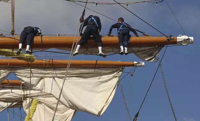 Sailors work on the yard arms of the Cuauhtémoc, Sunday, May 18, 2025 in New York. The masted Mexican Navy training ship collided with the Brooklyn Bridge the night before. (AP Photo/Yuki Iwamura)