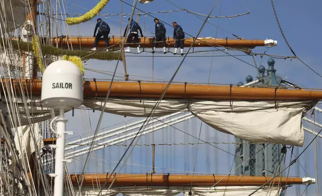 Sailors work on the yard arms of the Cuauhtémoc, Sunday, May 18, 2025 in New York. The masted Mexican Navy training ship collided with the Brooklyn Bridge the night before. (AP Photo/Yuki Iwamura)