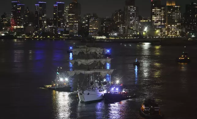 Tug boats assist the Cuauhtémoc, a masted Mexican Navy training ship, toward Pier 35 after it collided with the Brooklyn Bridge, Saturday, May 17, 2025, in New York. (AP Photo/Yuki Iwamura)