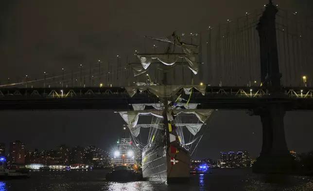 A tug boat helps stabilize the Cuauhtémoc, a masted Mexican Navy training ship as it sits stranded near the Manhattan Bridge after colliding with the Brooklyn Bridge, Saturday, May 17, 2025, in New York. (AP Photo/Yuki Iwamura)
