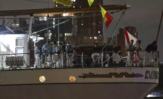Crew members aboard the Cuauhtémoc, a masted Mexican Navy training ship, gather on deck after the ship collided with the Brooklyn Bridge, Saturday, May 17, 2025, in New York. (AP Photo/Yuki Iwamura)