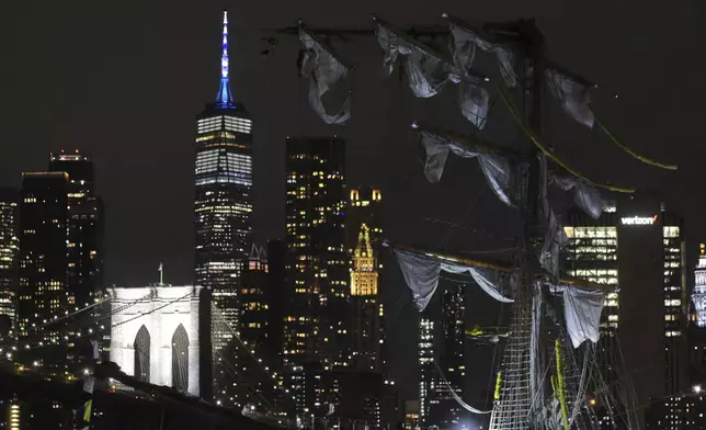 The New York skyline and Brooklyn Bridge are framed in one of the snapped masts of a Mexican Navy training ship after it collided with the Brooklyn Bridge, Saturday, May 17, 2025, in New York. (AP Photo/Yuki Iwamura)