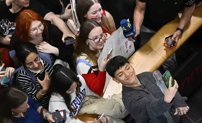 JJ, right, from Austria arrives at the airport in Vienna, Austria, Sunday, May 18, 2025, after winning the Grand Final of the 69th Eurovision Song Contest, in Basel yesterday. (AP Photo/Denes Erdos)
